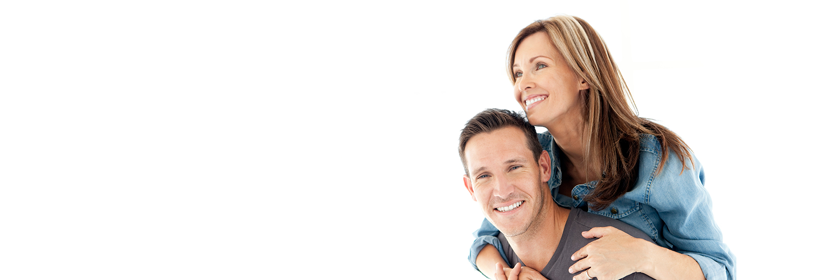 Smiling adult couple embracing, representing health, longevity, and overall wellness.